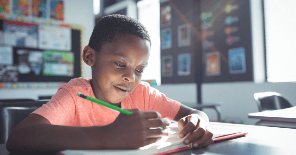 african american kid writing in school
